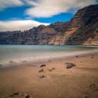 At the foot of the Los Gigantes cliffs, a volcanic-sand beach opens onto the Atlantic, creating a striking setting along Tenerife’s western coast.