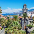 In the centre of Puerto de la Cruz stands the Church of Nuestra Señora de la Peña de Francia, distinguished by its dark-stone bell tower and the gardens of Plaza de la Iglesia.