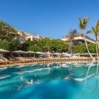 Surrounded by palm trees and lush gardens, one of the pools at the 4-star Servatur Isora Suites offers a peaceful retreat in the mild climate of Puerto de Santiago.