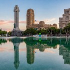 At sunset, Plaza de España reflects the Monument to the Fallen and the Cabildo Palace in its lake, offering a captivating view of the heart of Santa Cruz de Tenerife.
