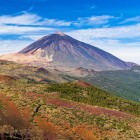 From Las Cañadas del Teide, the view stretches across volcanic expanses and the green Corona Forestal to the unmistakable summit of Mount Teide.