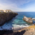 Along the coast of Puerto de Santiago, high lava cliffs enclose a small inlet where Atlantic waves surround spectacular volcanic formations.