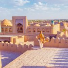 From Kuhna Ark, the view takes in Kalta Minor and the Muhammad Amin Khan Madrasa, amid turquoise tiles and earthen walls in the heart of ancient Khiva.