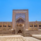 The Muhammad Rahim Khan II Madrasa captivates with its grand portal, blue tiles and elegant arches, revealing the splendour of 19th-century Khiva.
