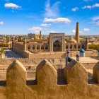 From the crenellated walls of Kuhna Ark, the view stretches across Itchan Kala, among madrasas, domes and minarets, revealing the timeless charm of ancient Khiva.