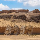 In the Kyzylkum Desert, the mud-brick walls of Ayaz Kala dominate the horizon, while ancient carts evoke the caravan routes of the Silk Road.