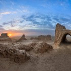 Among the arches and mud-brick walls of Ayaz Kala, sunset unfolds over the Kyzylkum, offering an evocative encounter with the ancient fortresses of Khorezm.