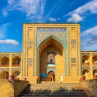 The Kukeldash Madrasa, built in the 16th century, welcomes travellers with its tall portal and two-tiered loggias, recalling Bukhara’s past along the Silk Road.