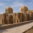 The Maghoki-Attori Mosque rises below the city level with brick domes and a carved Karakhanid portal, a rare testament to medieval Bukhara.