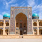 The Mir-i-Arab Madrasa, in the heart of Bukhara’s Poi-Kalyan complex, captivates with its grand decorated portal, turquoise domes and the elegant harmony of Islamic architecture.