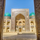The Mir-i-Arab Madrasa, a 16th-century jewel of the Poi-Kalyan complex, captivates visitors with its monumental decorated portal and turquoise domes, symbols of Islamic Bukhara.
