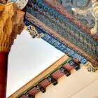 Within the Bahauddin Naqshband Complex, the ayvan of the Khakim Kushbegi Mosque captivates with its columns, muqarnas and ceilings painted in Bukhara’s traditional style.