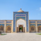 The entrance portal to the Bakhouddin Naqshband Complex, framed by blue tiles and arched niches, leads into one of Central Asia’s most revered sanctuaries.