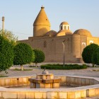 Amid Bukhara’s gardens, the Chashma Ayub Mausoleum stands out for its sequence of domes and conical roof, linked to the legend of the Spring of Job.