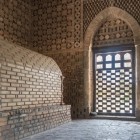 Inside the Ismail Samani Mausoleum, arches and intricate brickwork surround the burial chamber, revealing the harmony of 10th-century Samanid architecture.
