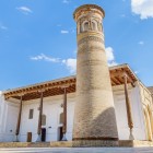 The Kasri Orifon Minaret, built in the 18th century, stands out for its intricate brickwork and eight-arched lantern, a silent guardian of the Sufi sanctuary.