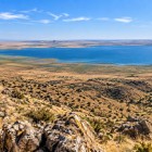 From above, Lake Aydarkul appears as a surprising expanse of water beside the Kyzylkum. Its contrast with the arid mountains makes the view unforgettable.