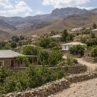Following the path through Ukhum, travelers encounter stone and earthen houses, vegetable gardens and fruit trees: a close-knit community nestled among the arid Nuratau Mountains.