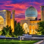 A panoramic view reveals the turquoise dome, decorated portals and towers of the Gur-e Amir, distinctive elements of Samarkand's Timurid architecture.