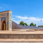 As you approach, the structure protecting the remains of the gigantic Ulugh Beg sextant comes into view, designed to measure the positions of celestial bodies with extraordinary precision.