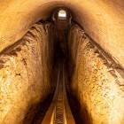 Inside, the underground section of the great astronomical arc appears: two parallel tracks follow the curve of the instrument once used by Ulugh Beg’s astronomers.