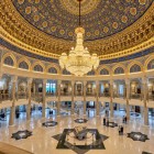 Entering the Amir Timur Museum, the grand central hall impresses with its finely decorated dome and monumental chandelier, introducing the collections dedicated to the Timurid era.
