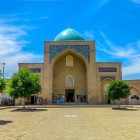 From the gardens of the complex, the Kaffal Shashi Mausoleum appears from a new perspective, with its monumental portal and dome rising above the building.