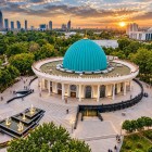The route continues towards the Amir Timur Museum, recognizable by its large turquoise dome and circular architecture, dedicated to the history of Timur and the Timurid dynasty.