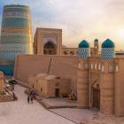 The journey reaches Khiva and the walls of Ichan Kala, an ancient caravan city where fortified gates, minarets and domes introduce the history of Khorezm.