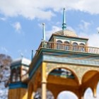 Approaching the pavilion reveals its carved arches, blue and gold shades, and slender spires, which define the distinctive profile of this historic building.