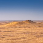 After lunch, the route returns to arid plains and low hills: the stark landscape of the Kyzylkum Desert accompanies the final stretch of the historic journey towards Bukhara.